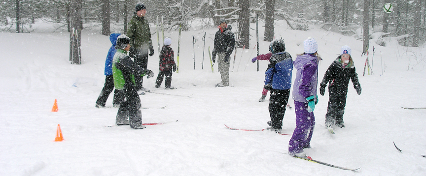Children learning to ski on a snowy day